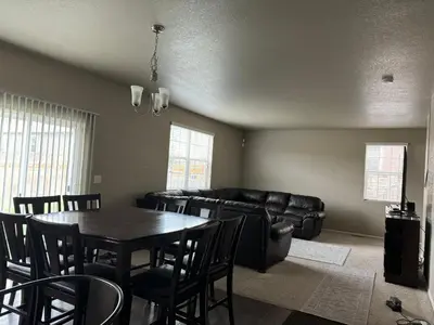 a living room with a table and a couch at Humble Home in Aurora