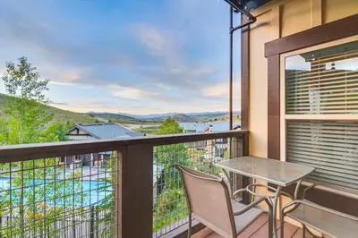 a balcony with a table and chairs and a view at Ski-InandSki-Out and Pool Access Granby Ranch Gem in Granby