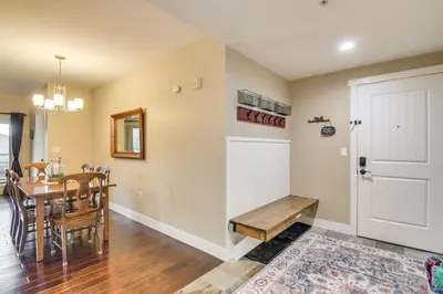 a dining room and kitchen with a table and a door at Ski-InandSki-Out and Pool Access Granby Ranch Gem in Granby