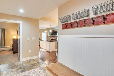 a kitchen and living room with a white wall at Ski-InandSki-Out and Pool Access Granby Ranch Gem in Granby