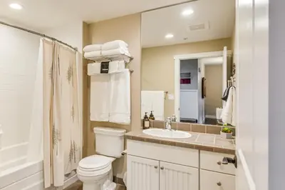 a bathroom with a toilet and a sink and a mirror at Ski-InandSki-Out and Pool Access Granby Ranch Gem in Granby