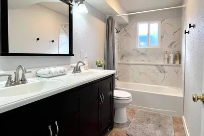 a bathroom with a sink and a tub and a toilet at Bright Home - Huge Backyard 20 min - Denver & Boulder in Broomfield