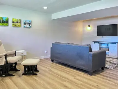 a living room with a couch and a flat screen tv at Bright Home - Huge Backyard 20 min - Denver & Boulder in Broomfield