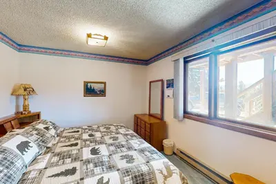 a bedroom with a bed and a window at Mallard Retreat in Tabernash