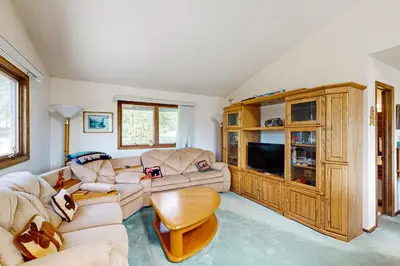 a living room with a couch and a tv at Mallard Retreat in Tabernash