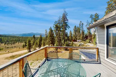 a balcony with a glass table and a view at Mallard Retreat in Tabernash