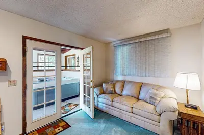 a living room with a couch and a tub at Mallard Retreat in Tabernash