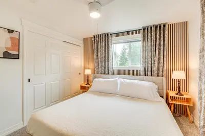 a bedroom with a white bed and a window at Loveland Retreat Near Dtwn with Outdoor Dining! in Loveland