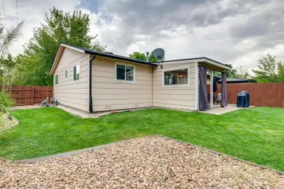 a small house with a lawn in front of it at Loveland Retreat Near Dtwn with Outdoor Dining! in Loveland
