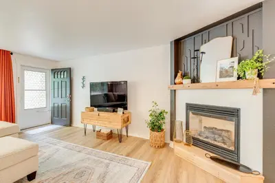 a living room with a fireplace and a tv at Loveland Retreat Near Dtwn with Outdoor Dining! in Loveland