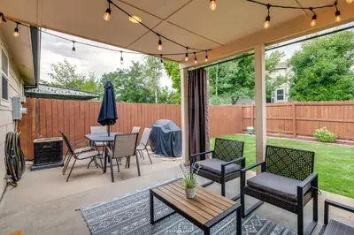 a patio with a table and chairs and a fence at Loveland Retreat Near Dtwn with Outdoor Dining! in Loveland