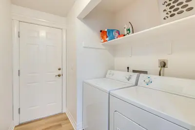 a white laundry room with a washer and dryer at Loveland Retreat Near Dtwn with Outdoor Dining! in Loveland