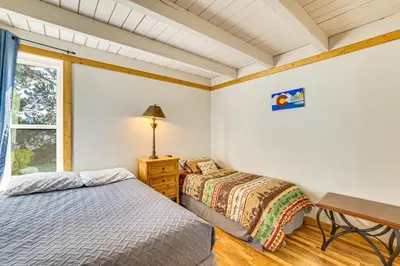a bedroom with two beds and a desk and a window at Mtn-View Condo with Community Perks in Silverthorne in Silverthorne
