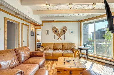 a living room with leather couches and a table at Mtn-View Condo with Community Perks in Silverthorne in Silverthorne