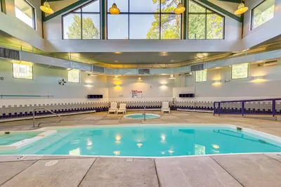 a large swimming pool in a building with windows at Mtn-View Condo with Community Perks in Silverthorne in Silverthorne