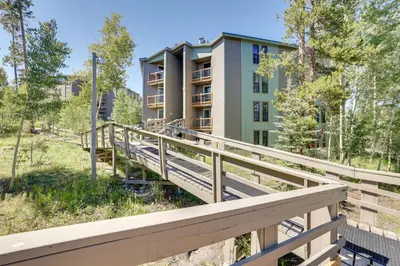 a boardwalk leading to a building with a building at Mtn-View Condo with Community Perks in Silverthorne in Silverthorne