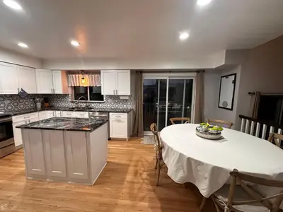 a kitchen with a table with a white table cloth on it at Charming Broomfield Home Close To Everything! in Broomfield
