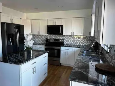 a kitchen with white cabinets and black appliances at Charming Broomfield Home Close To Everything! in Broomfield