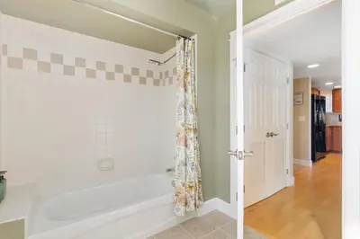 a bathroom with a white tub and a shower at Lee Martinez Loft Near Poudre Trail and Old Town in Fort Collins