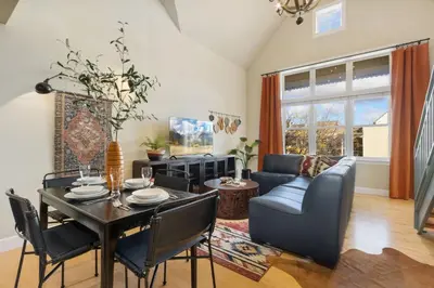 a living room with a table and a couch at Lee Martinez Loft Near Poudre Trail and Old Town in Fort Collins