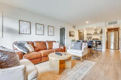 a living room with a couch and a table at Patio and Dillon Reservoir Views Chic Frisco Condo! in Frisco