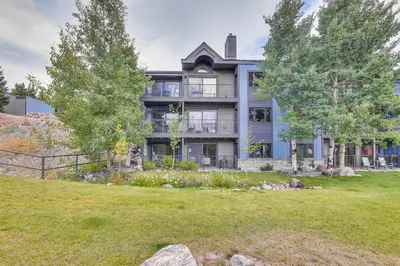 an image of a large house with a yard at Patio and Dillon Reservoir Views Chic Frisco Condo! in Frisco