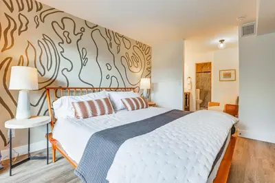 a bedroom with a large bed with a wall mural at Patio and Dillon Reservoir Views Chic Frisco Condo! in Frisco