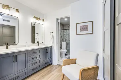 a bathroom with a sink and a chair at Patio and Dillon Reservoir Views Chic Frisco Condo! in Frisco