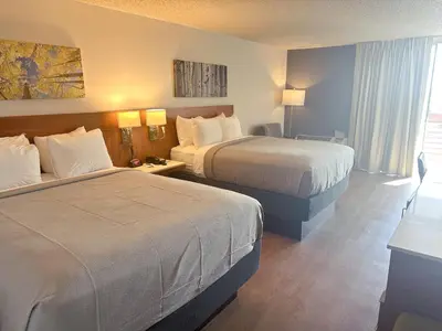 a hotel room with two beds and a window at Quality Inn & Suites Fort Collins East in Fort Collins