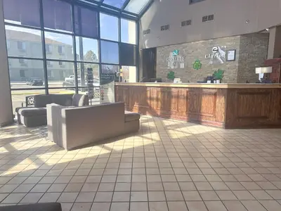 a lobby with couches and a bar in a restaurant at Quality Inn & Suites Fort Collins East in Fort Collins