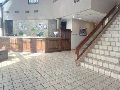 a lobby with stairs and a counter in a building at Quality Inn & Suites Fort Collins East in Fort Collins