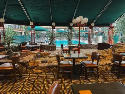 a restaurant with tables and chairs and a pool at Quality Inn & Suites Fort Collins East in Fort Collins