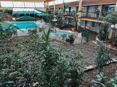 an empty courtyard with a swimming pool in a building at Quality Inn & Suites Fort Collins East in Fort Collins