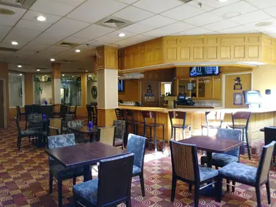 a restaurant with tables and chairs and a bar at Quality Inn & Suites Fort Collins East in Fort Collins