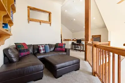 a living room with a couch and a table at Antlers Gulch Retreat townhouse in Keystone