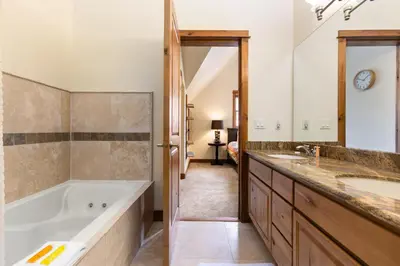a bathroom with a tub and a sink at Antlers Gulch Retreat townhouse in Keystone