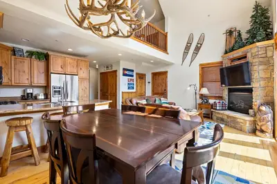 a kitchen with a large wooden table in a room at Antlers Gulch Retreat townhouse in Keystone
