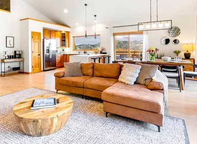 a living room with a couch and a table at Epic Views - Hot Tub - Starlink Internet - Dogs OK in Evergreen