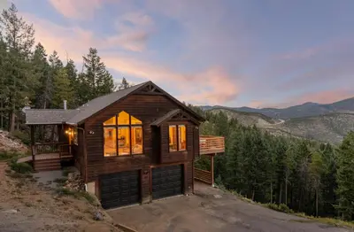 a cabin in the woods with a view of the mountains at Epic Views - Hot Tub - Starlink Internet - Dogs OK in Evergreen