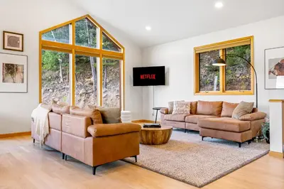 a living room with two couches and a tv at Epic Views - Hot Tub - Starlink Internet - Dogs OK in Evergreen