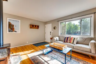 a living room with a couch and a window at Central Boulder Home with Outdoor Oasis, Walk to CU! in Boulder