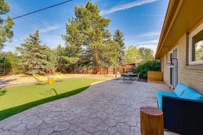 a patio with chairs and a yard with grass at Central Boulder Home with Outdoor Oasis, Walk to CU! in Boulder