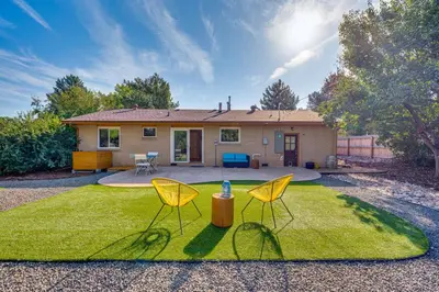two chairs sitting on the grass in front of a house at Central Boulder Home with Outdoor Oasis, Walk to CU! in Boulder
