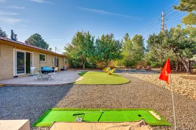 a yard with a green lawn and a flag at Central Boulder Home with Outdoor Oasis, Walk to CU! in Boulder