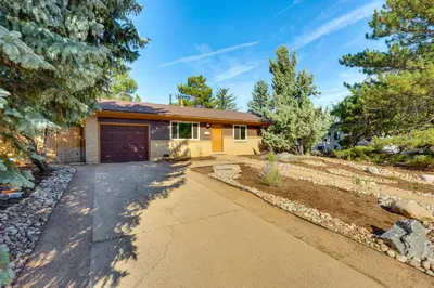 a house with a garage and a driveway at Central Boulder Home with Outdoor Oasis, Walk to CU! in Boulder