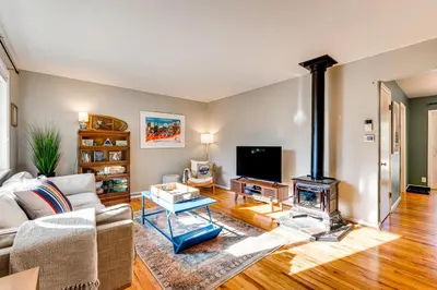 a living room with a couch and a fireplace at Central Boulder Home with Outdoor Oasis, Walk to CU! in Boulder