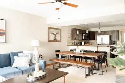 a living room with a blue couch and a table at Alluring Rocky MTN Getaway - Free Parking - Fraser in Fraser