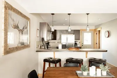 a kitchen and dining room with a table and chairs at Alluring Rocky MTN Getaway - Free Parking - Fraser in Fraser