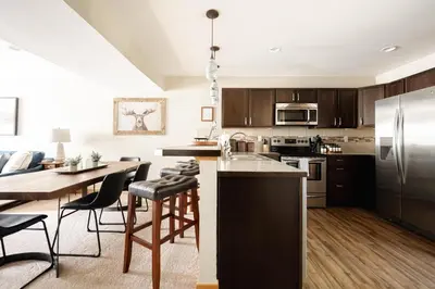 a kitchen with a table and a kitchen with a dining room at Alluring Rocky MTN Getaway - Free Parking - Fraser in Fraser
