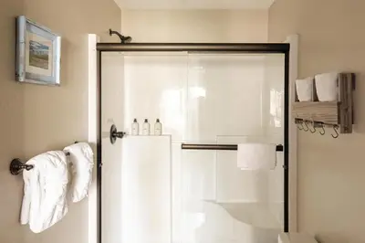 a bathroom with a shower with white towels at Alluring Rocky MTN Getaway - Free Parking - Fraser in Fraser